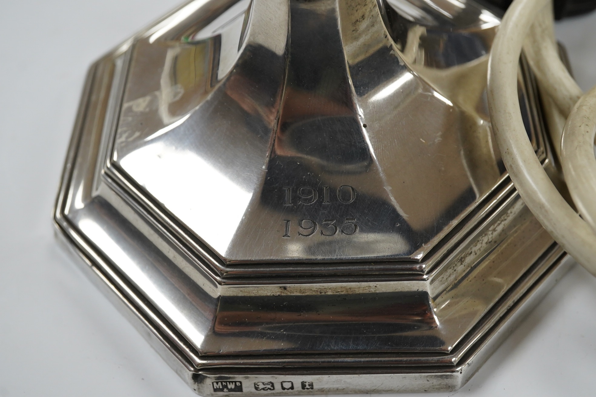 A George V silver octagonal electric lamp base, by Mappin & Webb, London, 1934, with engraved dates, overall 34.2cm. Condition - fair